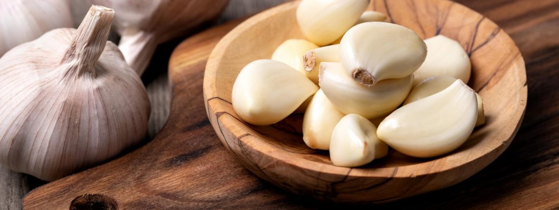 Garlic Cloves and Bulb in vintage wooden bowl