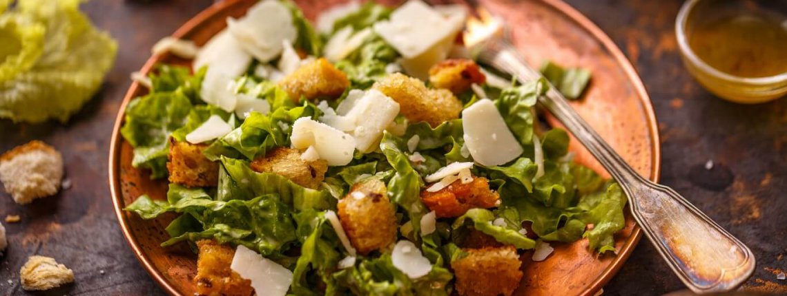 Caesar salad on vintage table. Healthy food style