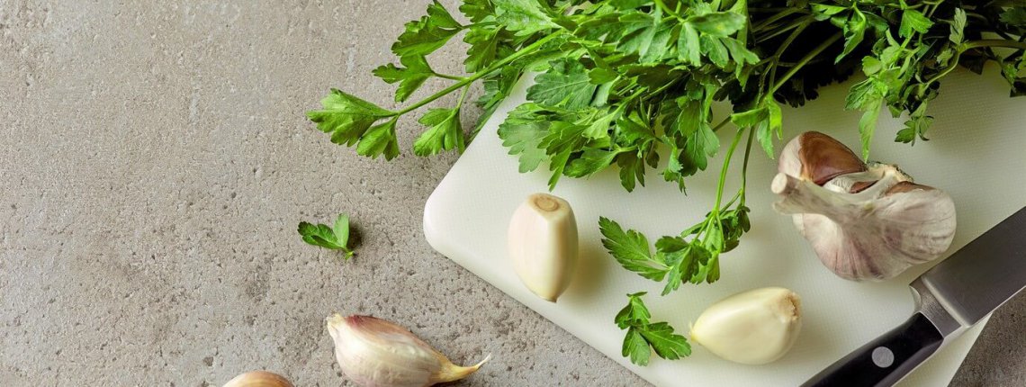 Parsley and garlic on cutting board